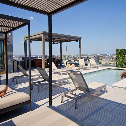 Residents lounging under rooftop cabanas.