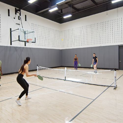 Residents playing tennis in a multi-functional court