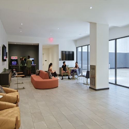 Resident seated near arcade room and basketball court