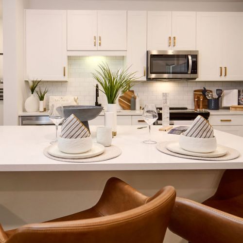 Kitchen island with place settings and leather bar stools