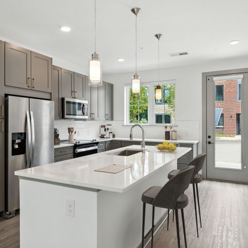 Shaker style kitchen cabinets with tile backsplash and under cabinet lighting