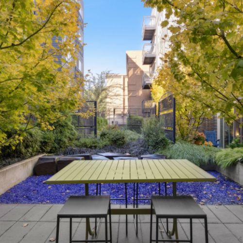 Outdoor seating in landscaped garden at Smith & Burns Seattle
