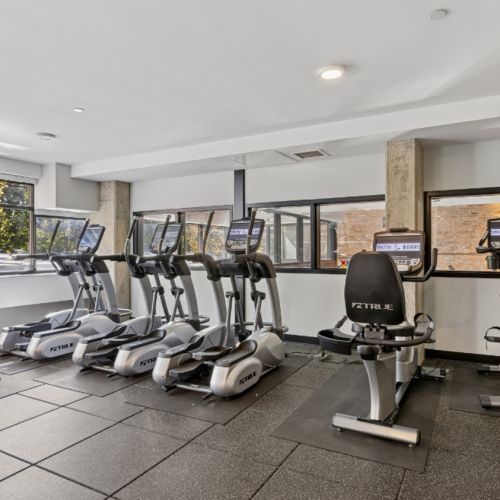 Fitness center at Smith & Burns Seattle apartments with modern equipment