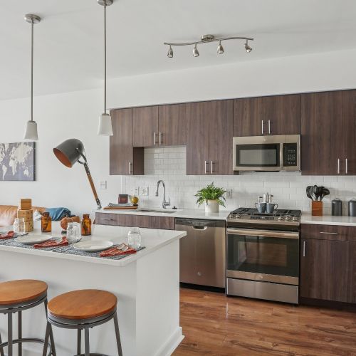White island, barstools, and darkwood kitchen cabinets 