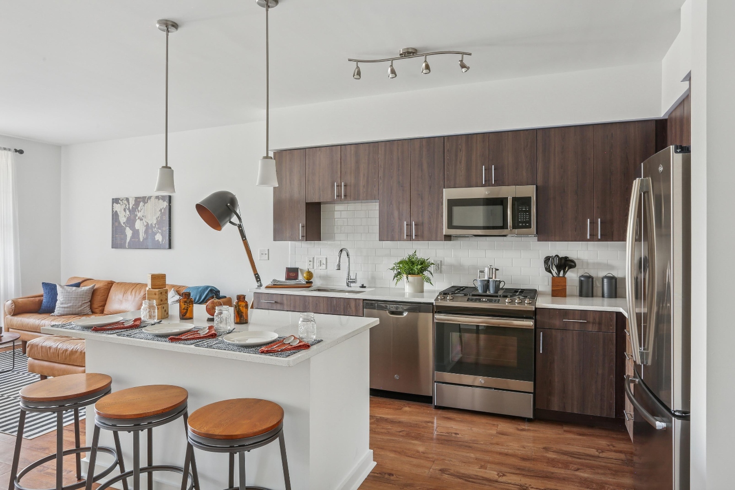 White island, barstools, and darkwood kitchen cabinets 