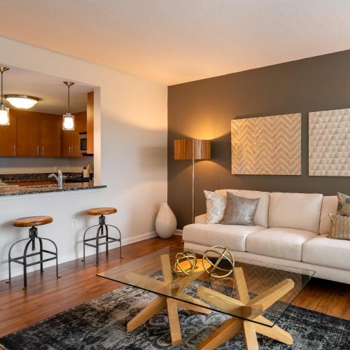 Living room with vinyl plank flooring and view of kitchen